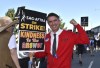 Actor Walt Keller dressed as Mister Rogers carries a sign on the picket line outside Universal Studios on Friday, Aug. 4, 2023, in Universal City, Calif. The actors strike comes more than two months after screenwriters began striking in their bid to get better pay and working conditions. (Photo by Richard Shotwell/Invision/AP)