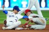 Philadelphia Phillies' Bryson Stott (right) steals second base ahead of the tag from Toronto Blue Jays second baseman Cavan Biggio (8) during seventh inning MLB interleague baseball action in Toronto on Tuesday, August 15, 2023. THE CANADIAN PRESS/Nathan Denette