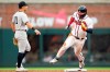 Atlanta Braves' Ronald Acuña Jr. runs past New York Yankees shortstop Anthony Volpe on a wild throw to first base on a pickoff attempt during the first inning of a baseball game Tuesday, Aug. 15, 2023, in Atlanta. (AP Photo/Hakim Wright Sr.)
