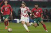 FILE - Croatia's Lovro Majer, center, and Morocco's Yahya Jabrane fight for the ball during the World Cup third-place playoff soccer match between Croatia and Morocco at Khalifa International Stadium in Doha, Qatar, on Dec. 16, 2022. Wolfsburg signed Croatia attacking midfielder Lovro Majer from French side Rennes on Wednesday Aug. 16, 2023. (AP Photo/Thanassis Stavrakis, File)