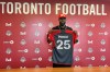 Newly-acquired German forward Prince Owusu holds up his Toronto FC jersey at the MLS club’s training facility in Toronto on Tuesday, Aug. 15, 2023. THE CANADIAN PRESS/Neil Davidson
