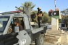 Libyan security forces stand guard in Tripoli, Libya, Tuesday, Aug. 16, 2023. Clashes between rival militias in Libya's capital killed a few dozen people and left residents trapped in their homes Tuesday, unable to escape the violence, medical authorities said. (AP Photo/Yousef Murad)