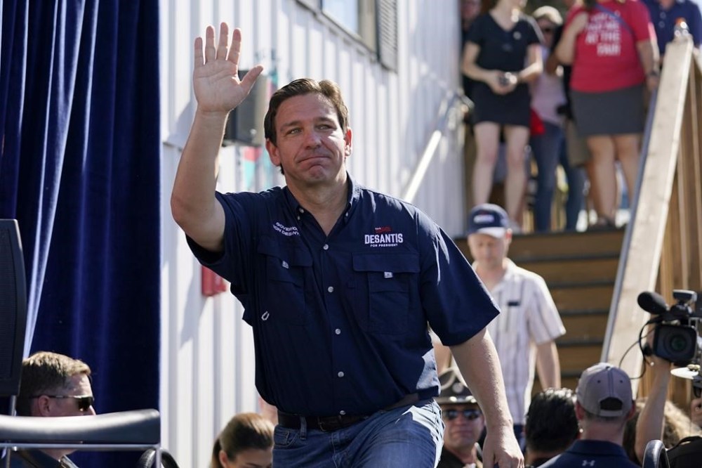 Republican presidential candidate Florida Gov. Ron DeSantis waves as he steps onto the stage for a Fair-Side Chat with Iowa Gov. Kim Reynolds at the Iowa State Fair, Saturday, Aug. 12, 2023, in Des Moines, Iowa. (AP Photo/Jeff Roberson)