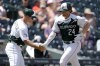 Colorado Rockies third base coach Warren Schaeffer, left, congratulates Ryan McMahon as he circles the bases after hitting a solo home run off of Arizona Diamondbacks starting pitcher Slade Cecconi in the first inning of a baseball game Wednesday, Aug. 16, 2023, in Denver. (AP Photo/David Zalubowski)