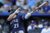 Seattle Mariners' Ty France hits an RBI single during the first inning of a baseball game against the Kansas City Royals Wednesday, Aug. 16, 2023, in Kansas City, Mo. (AP Photo/Charlie Riedel)