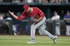 Los Angeles Angels relief pitcher Carlos Estevez celebrates after the final out in the team's 2-0 win in a baseball game against the Texas Rangers, Wednesday, Aug. 16, 2023, in Arlington, Texas. (AP Photo/Tony Gutierrez)