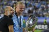 Manchester City's head coach Pep Guardiola, left, celebrates with Manchester City's Erling Haaland after winning the UEFA Super Cup Final soccer match between Manchester City and Sevilla at Georgios Karaiskakis stadium in Piraeus port, near Athens, Greece, Wednesday, Aug. 16, 2023. (AP Photo/Thanassis Stavrakis)
