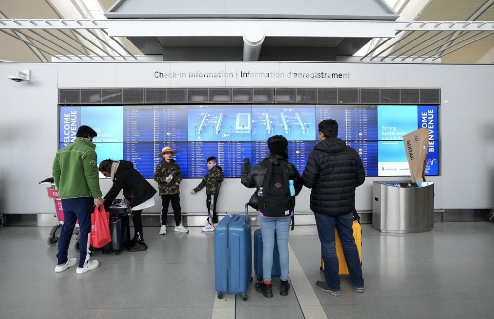 People are shown at Pearson International Airport in Toronto on Friday, March 10, 2023. The Supreme Court of Canada has granted an appeal for a group airlines looking to quash rules that bolster compensation for passengers subjected to delayed flights and damaged luggage.THE CANADIAN PRESS/Nathan Denette