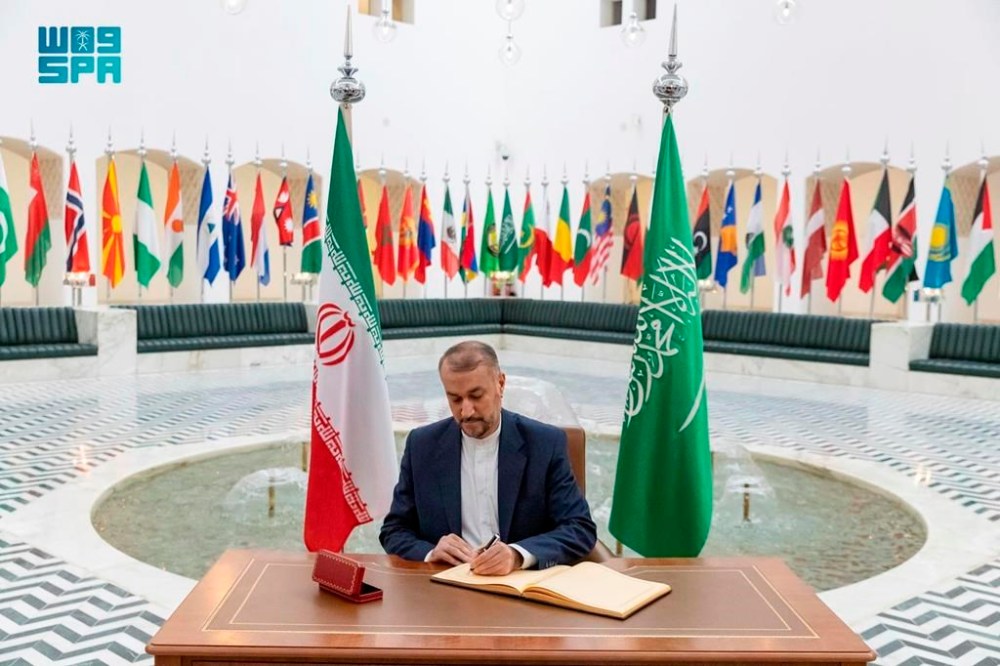 In this handout image released by the state-run Saudi Press Agency, Iranian Foreign Minister Hossein Amirabdollahian signs a register at the Saudi Foreign Ministry in Riyadh, Saudi Arabia, Thursday, Aug. 17, 2023. Iran's foreign minister traveled to Saudi Arabia on Thursday, marking the first trip to the kingdom by Tehran's top diplomat in years after the two nations reached a détente with Chinese mediation. (Abdulrahman al-Abdulsalam/Saudi Press Agency, via AP)