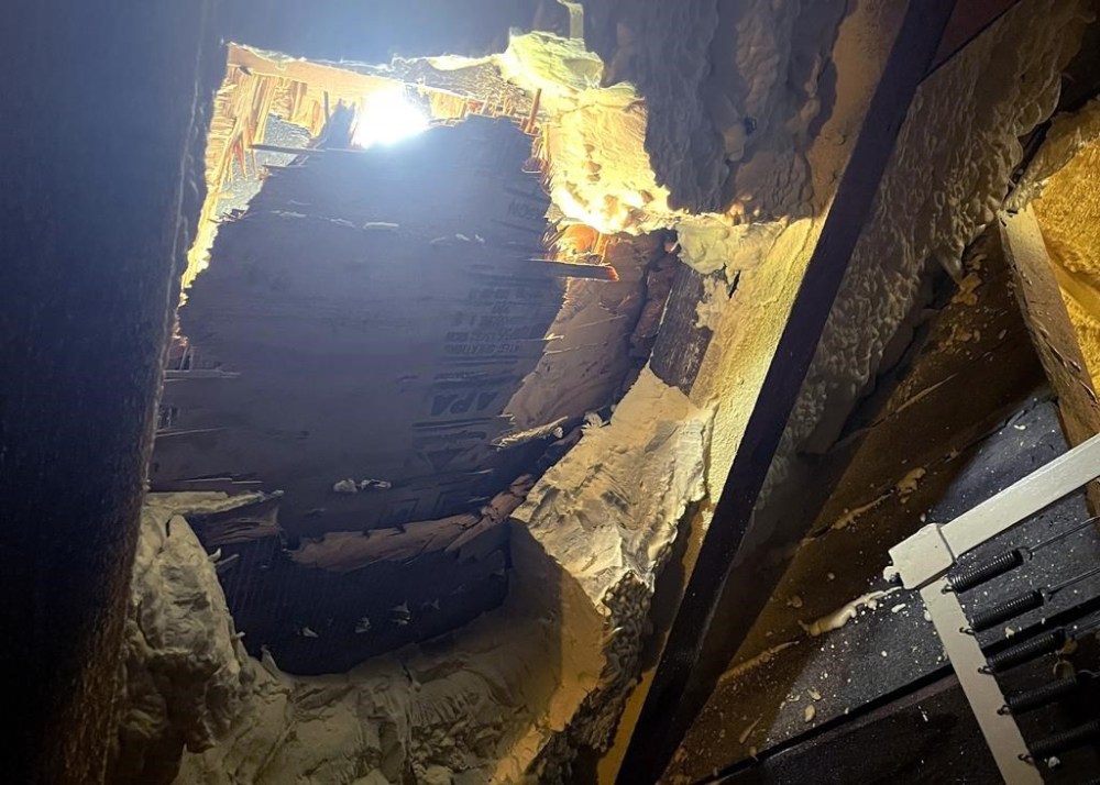 This Monday, Aug. 14, 2023 photo provided by Amelia Rainville shows damage to the inside of the roof to her home, in Shirley, Mass., where a chunk of ice landed on the roof late Sunday, Aug. 13, 2023. Jeff Ilg said he and his wife Amelia Rainville suspect the ice fell off an airplane traveling to Boston Logan International Airport. The couple and their two children were not hurt when the ice chunk, estimated to be 15 to 20 pounds (6 to 9 kilograms), hit the roof Sunday. (Amelia Rainville via AP)