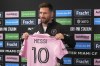 Inter Miami's Lionel Messi holds up his team jersey during a news conference, Thursday, Aug. 17, 2023, in Fort Lauderdale, Fla. (AP Photo/Marta Lavandier)