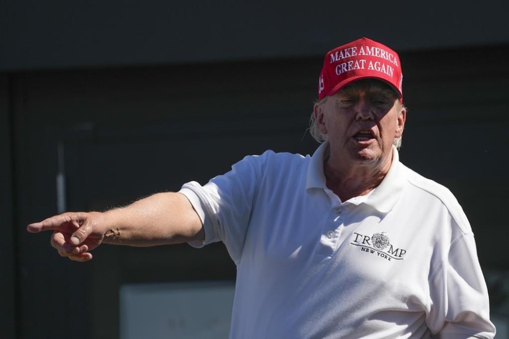 Former President Donald Trump talks to people in the crowd during the final round of the Bedminster Invitational LIV Golf tournament in Bedminster, N.J., Sunday, Aug. 13, 2023. (AP Photo/Seth Wenig)