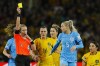 Referee Tori Penso shows a yellow card to England's Alex Greenwood, second from right, during the Women's World Cup semifinal soccer match between Australia and England at Stadium Australia in Sydney, Australia, Wednesday, Aug. 16, 2023. (AP Photo/Abbie Parr)