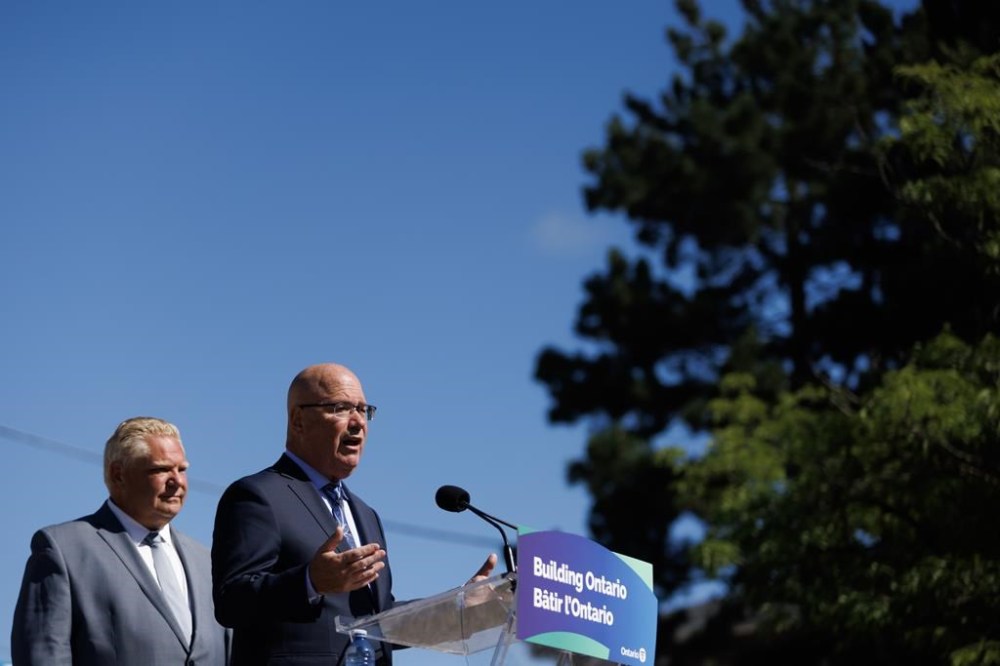First Nations leaders from across Ontario are calling for Housing Minister Steve Clark's resignation or removal over his handling of changes to protected Greenbelt land. Ontario Premier Doug Ford listens as Clark speaks during a press conference in Mississauga, Ont., Friday, Aug. 11, 2023. THE CANADIAN PRESS/Cole Burston