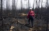More residents of northwestern Quebec have been evacuated due to high intensity forest fires raging near Cree communities and Hydro-Québec instrastructure. Society of Protection of Forests from Fire (SOPFEU) prevention agent Melanie Morin walks through an area of burned forest in the area surrounding Lebel-sur-Quevillon, Que., Wednesday, July 5, 2023. THE CANADIAN PRESS/Adrian Wyld