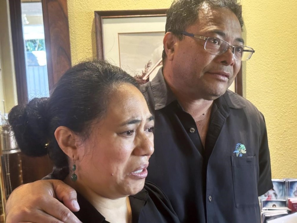 CORRECTS SPELLING OF LAST NAME TO SAMISONI INSTEAD OF SAMISANI - Taufa Samisoni, right, and his wife Katalina speak after attending Mass at Sacred Hearts Mission Church in Kapalua, Hawaii on Sunday, Aug. 13, 2023. Taufa Samisoni's uncle, aunt, cousin and cousin's 7-year-old son died in a wildlife that burned most of the Maui town of Lahaina. (AP Photo/Audrey McAvoy)