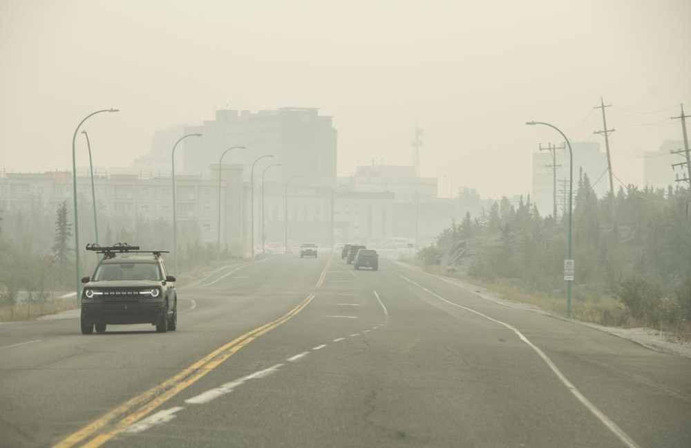 The streets of Yellowknife are empty after nearly all residents from the capital of the Northwest Territories were forced to flee under the threat of an encroaching wildfire. Heavy smoke from nearby wildfires fills the sky in Yellowknife, Tuesday, Aug. 15, 2023. THE CANADIAN PRESS/Angela Gzowski
