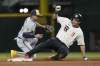 Texas Rangers' Corey Seager (5) slides into second base for a double against Milwaukee Brewers shortstop Willy Adames, left, during the sixth inning of a baseball game in Arlington, Texas, Friday, Aug. 18, 2023. (AP Photo/LM Otero)