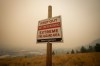 British Columbia's desperate battle against hundreds of wildfires continues on multiple fronts Sunday. A warning sign about fire risk is seen as smoke from wildfires fills the air, in Kelowna, B.C., Saturday, Aug. 19, 2023. THE CANADIAN PRESS/Darryl Dyck
