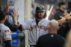 San Francisco Giants' Brandon Crawford (35) celebrates in the dugout after scoring off of a single hit by Joc Pederson during the third inning of a baseball game against the Los Angeles Angels in Anaheim, Calif., Tuesday, Aug. 8, 2023. (AP Photo/Ashley Landis)