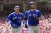 Toronto Blue Jays' Kevin Kiermaier, right, jogs to the dugout with Danny Jansen after hitting a two-run home run against the Cincinnati Reds in the second inning of a baseball game in Cincinnati, Sunday, Aug. 20, 2023. (AP Photo/Jeff Dean)