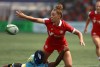 Canada's Chloe Daniels passes the ball away before being pulled down by St. Lucia's Renetta Fredericks during women's semi-final rugby action at the Rugby Sevens Paris 2024 Olympic qualification event at Starlight Stadium in Langford, B.C., Sunday, Aug. 20, 2023. THE CANADIAN PRESS/Chad Hipolito