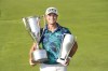 Viktor Hovland holds the Western Golf Association Trophy, left, and the BMW Championship Trophy after winning in the final round of the BMW Championship golf tournament, Sunday, Aug. 20, 2023, in Olympia Fields, Ill. (AP Photo/Charles Rex Arbogast)