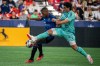 Vancouver Whitecaps' Brian White (24) and San Jose Earthquakes midfielder Carlos Gruezo (7) battle for control of the ball during first half MLS soccer action in Vancouver on Sunday, August 20, 2023. THE CANADIAN PRESS/Ethan Cairns