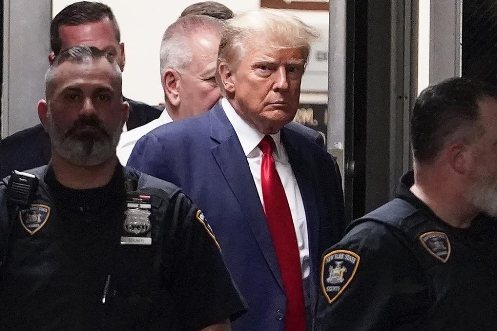 FILE - Former President Donald Trump is escorted to a courtroom, April 4, 2023, in New York. (AP Photo/Mary Altaffer, File)