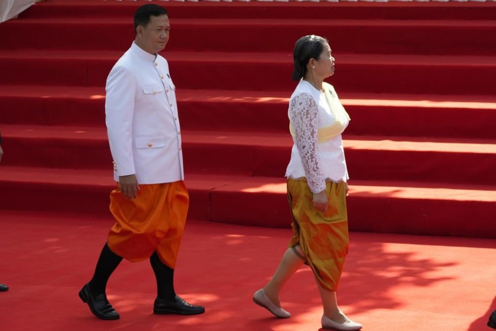 Hun Manet designate prime minister and son of Cambodia Prime Minister Hun Sen, also army chief, walks together with Men Sam An, right, Deputy Prime Minister, in front of the National Assembly in Phnom Penh, Cambodia, Monday, Aug. 21, 2023. (AP Photo/Heng Sinith)