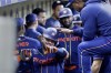 Houston Astros' Chas McCormick, left, gets a tap on the helmet by Framber Valdez, right, in the dugout as they celebrate after the three-run home run by McCormick against the Boston Red Sox during the fourth inning of a baseball game Monday, Aug. 21, 2023, in Houston. (AP Photo/Michael Wyke)