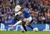 Rangers' Cyriel Dessers battles for the ball with PSV Eindhoven's Ibrahim Sangare, during the Champions League qualifying first leg soccer match between Glasgow Rangers and PSV Eindhoven, at Ibrox Stadium, in Glasgow, Scotland, Tuesday, Aug. 22, 2023. (Andrew Milligan/PA via AP)