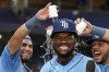 Tampa Bay Rays' Osleivis Basabe, center, reacts as Jonathan Aranda, left, and Rene Pinto pour water on his head after the Rays defeated the Colorado Rockies during a baseball game Tuesday, Aug. 22, 2023, in St. Petersburg, Fla. Basabe had a grand slam in the game. (AP Photo/Chris O'Meara)