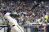 Milwaukee Brewers' Christian Yelich hits a double during the third inning of a baseball game against the Minnesota Twins Tuesday, Aug. 22, 2023, in Milwaukee. (AP Photo/Morry Gash)