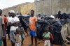 Migrants stuck in Niamey, Niger, pose in their makeshift camp Tuesday, Aug. 22, 2023. Some 7,000 migrants are stranded in Niger unable to go home after a coup last month where members of the presidential guard overthrew the country's democratically elected. Niger's junta has closed its airspace and regional countries have imposed severe travel and economic sanctions, shuttering land borders and making it hard for people to leave (AP Photo/Sam Mednick)