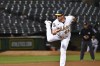 Oakland Athletics pitcher Trevor May watches a throw to a Kansas City Royals batter during the ninth inning of a baseball game in Oakland, Calif., Tuesday, Aug. 22, 2023. (AP Photo/Nic Coury)