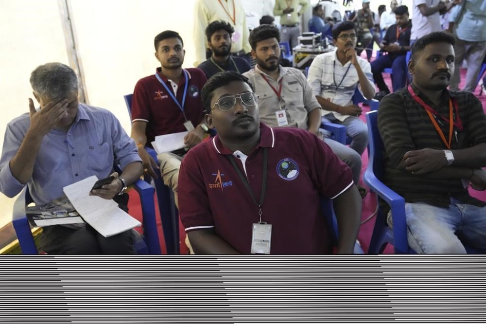 Indian Space Research Organization (ISRO) scientists watch the descent of spacecraft Chandrayaan-3 on the moon at ISRO's Telemetry, Tracking and Command Network facility in Bengaluru, India, Wednesday, Aug. 23, 2023. India was counting down to landing a spacecraft near the moon's south pole Wednesday, an unchartered territory that scientists believe could hold important reserves of frozen water and precious elements. (AP Photo/Aijaz Rahi)