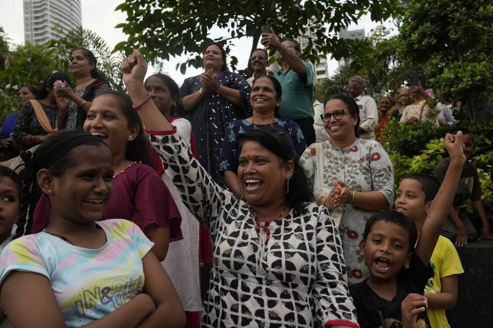 People celebrate as they watch a live telecast of the landing og Chandrayaan-3, or “moon craft” in Sanskrit, in Mumbai, India, Wednesday, Aug. 23, 2023. India has landed a spacecraft near the moon’s south pole, an unchartered territory that scientists believe could hold vital reserves of frozen water and precious elements, as the country cements its growing prowess in space and technology. (AP Photo/Rajanish Kakade)