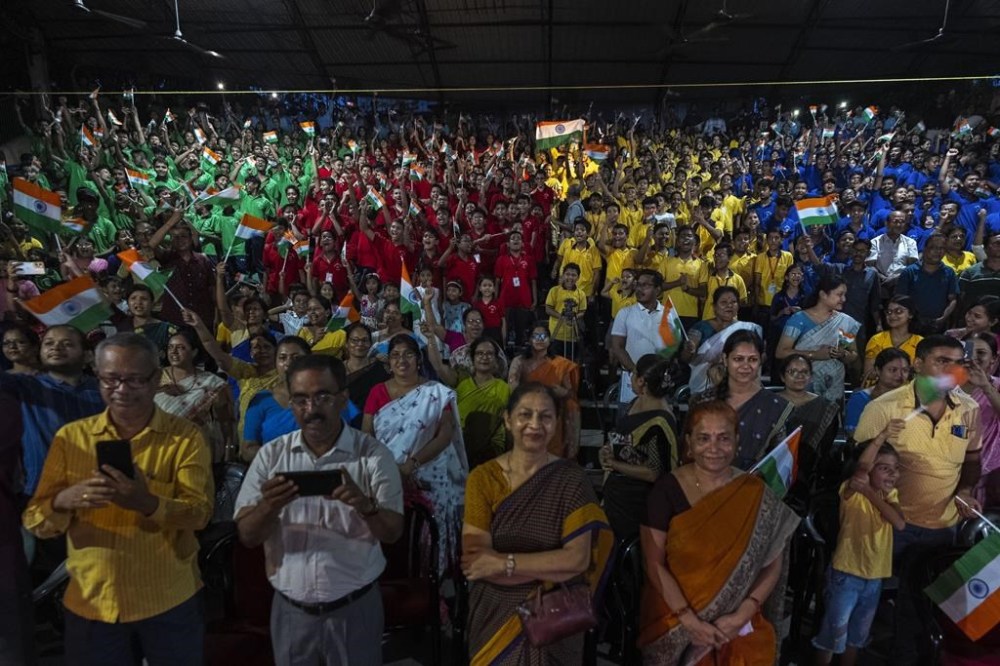 Schoolchildren celebrate the successful landing of spacecraft Chandrayaan-3 on the moon, in a school in Guwahati, India, Wednesday, Aug. 23, 2023. India has landed a spacecraft near the moon's south pole, an unchartered territory that scientists believe could hold vital reserves of frozen water and precious elements, as the country cements its growing prowess in space and technology. (AP Photo/Anupam Nath)