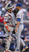 New York Mets catcher Francisco Alvarez speaks to starting pitcher Jose Quintana during the first inning of the team's baseball game against the Atlanta Braves, Wednesday, Aug. 23, 2023, in Atlanta. (AP Photo/Hakim Wright Sr.)