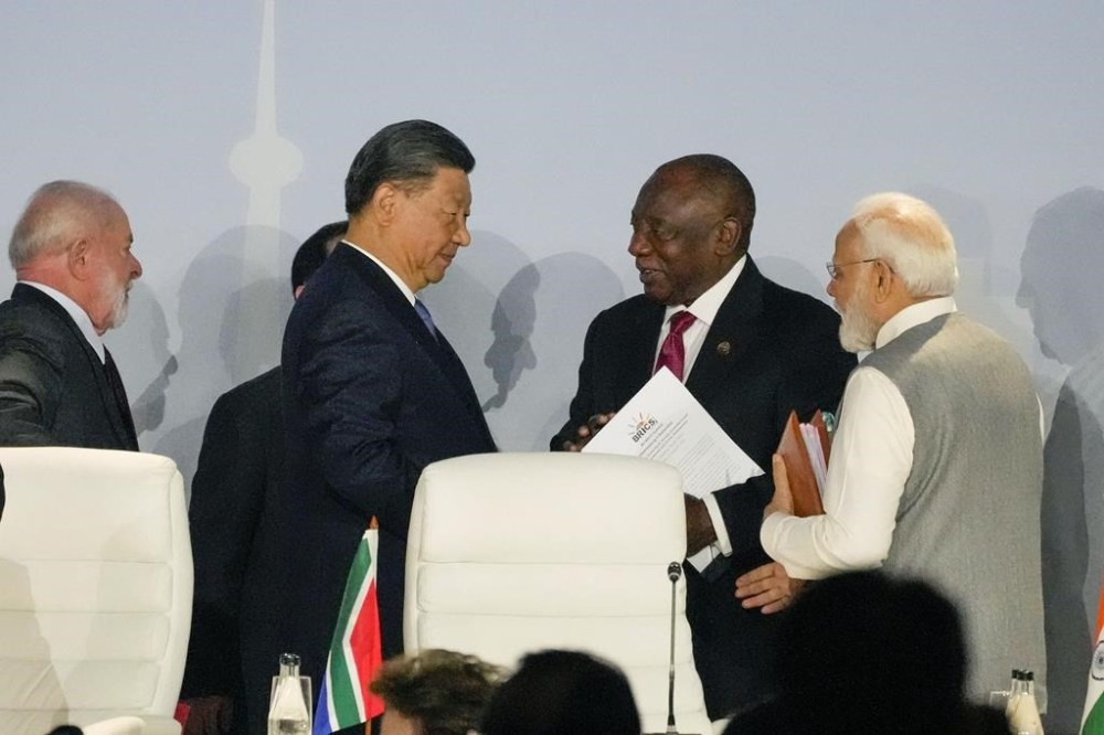 South African President Cyril Ramaphosa, centre right speaks to China's President Xi Jinping as President of Brazil Luiz Inacio Lula, left, and Prime Minister of India Narendra Modi look on, at the BRICS summit in Johannesburg, South Africa, Thursday, Aug. 24, 2023. (AP Photo/Themba Hadebe)