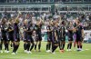 Bayern's players, including Harry Kane, right, celebrate their victory after the German Bundesliga soccer match between Werder Bremen and Bayern Munich, at the Weserstadion in Bremen, Germany, Friday, Aug. 18, 2023. (Axel Heimken/dpa via AP)
