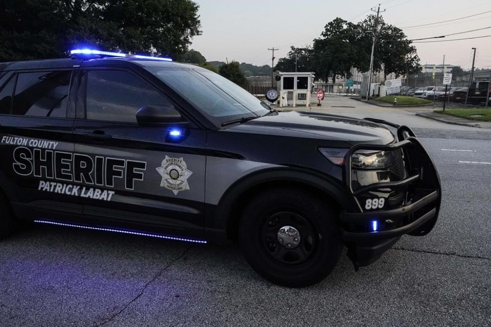 A Sheriff's vehicle patrols outside the Fulton County Jail, Thursday, Aug. 24, 2023, in Atlanta. Trump is charged alongside others, who are accused by Fulton County District Attorney Fani Willis of scheming to subvert the will of Georgia voters to keep the Republican president in the White House after he lost to Democrat Joe Biden. (AP Photo/Mike Stewart)