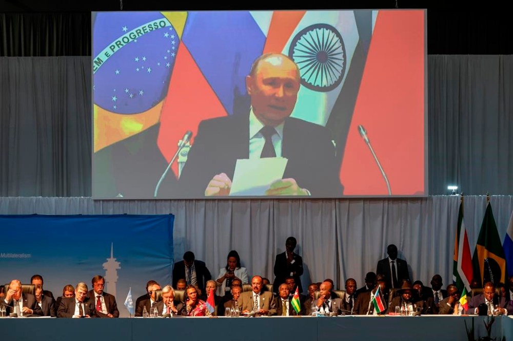 Russia's Foreign Minister Sergei Lavrov, left, Secretary-General of the United Nations Antonio Guterres, 3rd left, Eritrean President Isaias Afwerki, center, Togo's Foreign Minister Robert Dussey, 3rd right, South Sudanese President Salva Kiir, 2nd right, and Senegalese President Macky Sall, right, look on as Russian President Vladimir Putin delivers his remarks during a meeting during the 2023 BRICS Summit at the Sandton Convention Centre in Johannesburg Thursday, Aug. 24, 2023. (Marco Longari/Pool via AP)
