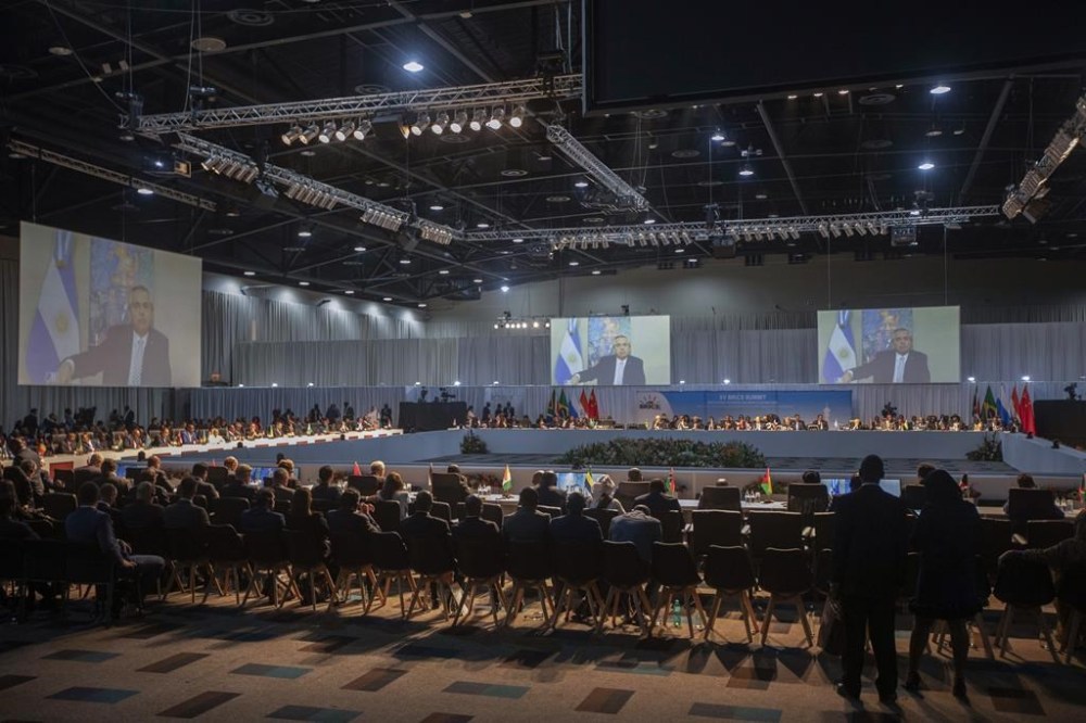 Argentine President Alberto Angel Fernandez appears on a screen as he addresses the 15th BRICS Summit, in Johannesburg, South Africa, Thursday, Aug. 24, 2023. The BRICS leaders announced that they would welcome six new members in January 2024: Iran, Argentina, Egypt, Ethiopia, Saudi Arabia and the United Arab Emirates. (Kim Ludbrook/Pool via AP)