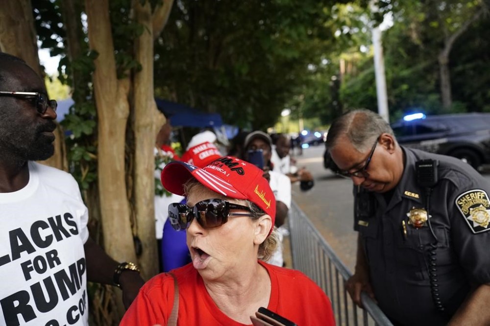 Former President Donald Trump's supporters gather outside of the Fulton County Jail, Thursday, Aug. 24, 2023, in Atlanta. (AP Photo/Brynn Anderson)