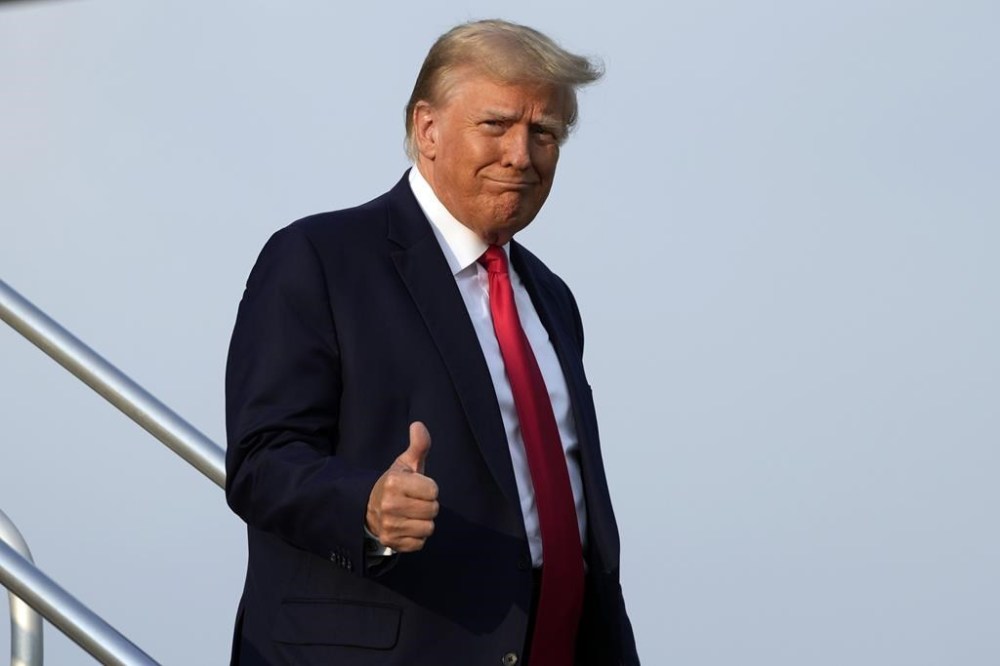 Former President Donald Trump steps off his plane as he arrives at Hartsfield-Jackson Atlanta International Airport, Thursday, Aug. 24, 2023, in Atlanta. Trump is headed to the Fulton County Jail. (AP Photo/Alex Brandon)