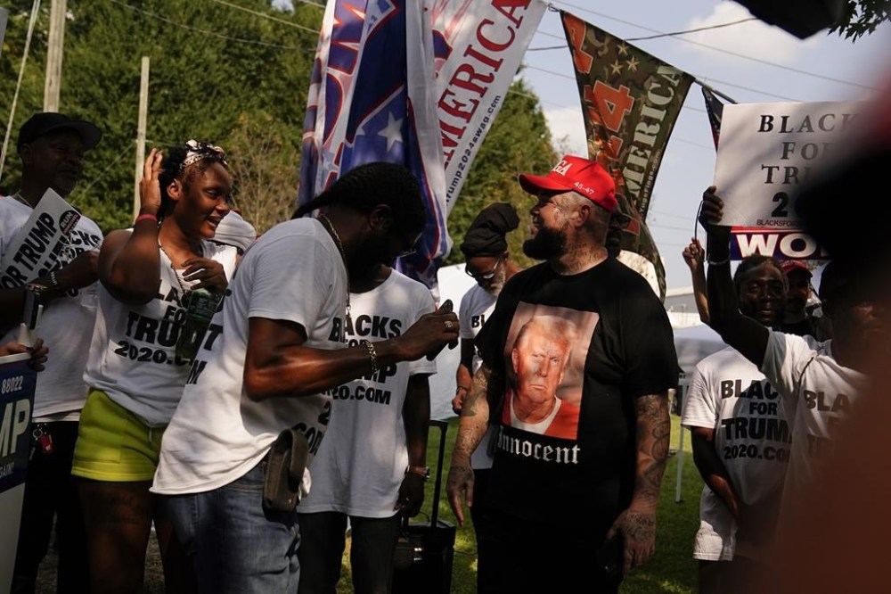 Supporters of former President Donald Trump gather outside of the Fulton County Jail, Thursday, Aug. 24, 2023, in Atlanta. (AP Photo/Brynn Anderson)