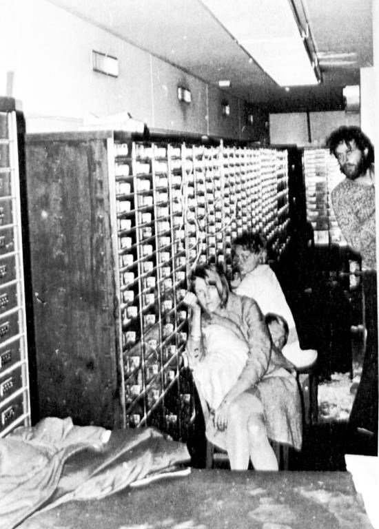 FILE - In this photo released by police, three of the four hostages and bank robber Clark Olofsson, standing right, are seen in a bank in Stockholm, Sweden, Aug. 27, 1973, shortly before the gunmen were overwhelmed by police. This week marks 50 years since a failed bank robbery that gave rise to the Stockholm syndrome, a term used in psychology to describe the bond that victims of kidnappings or hostage situations sometimes develop with their captors. (AP Photo, File)