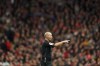FILE - Referee Mike Dean gestures during an English Premier League soccer match between Liverpool and Brighton and Hove Albion at Anfield Stadium, Liverpool, England, Saturday, Oct. 30, 2021. A former Premier League referee says he failed to correct a mistake while on video-review duty for a match last season to spare the on-field official “any more grief.” (AP Photo/Jon Super, File)